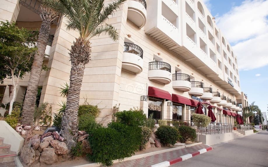Exterior view of resort hotels in Port El Kantaoui, Hammam Sousse, Tunisia, with modern buildings and landscaped grounds
