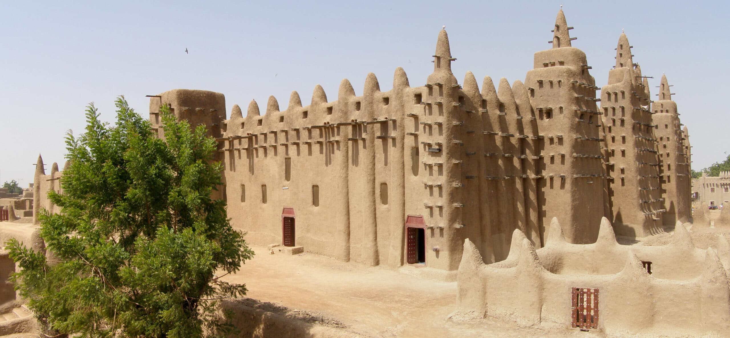 Full view of the Great Mosque of Djenné, Mali, showcasing its mud-brick structure and distinctive architecture
