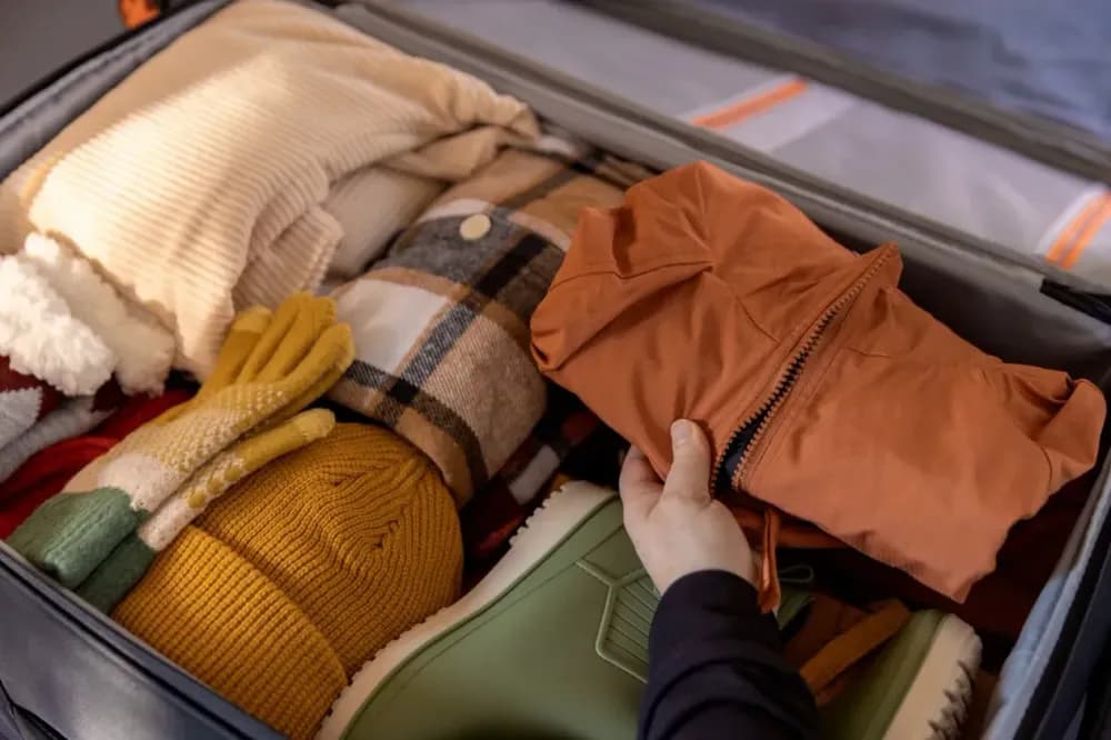 Fall travel outfit with layers, scarves, and cozy accessories