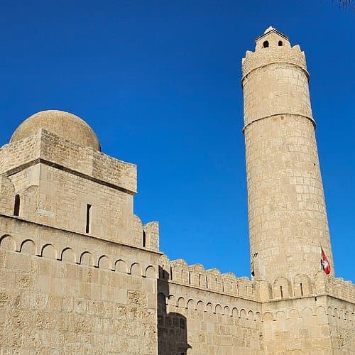 Establishing shot of the Ribat of Sousse, a stone fortress with towers and walls, located in Hammam Sousse, Tunisia