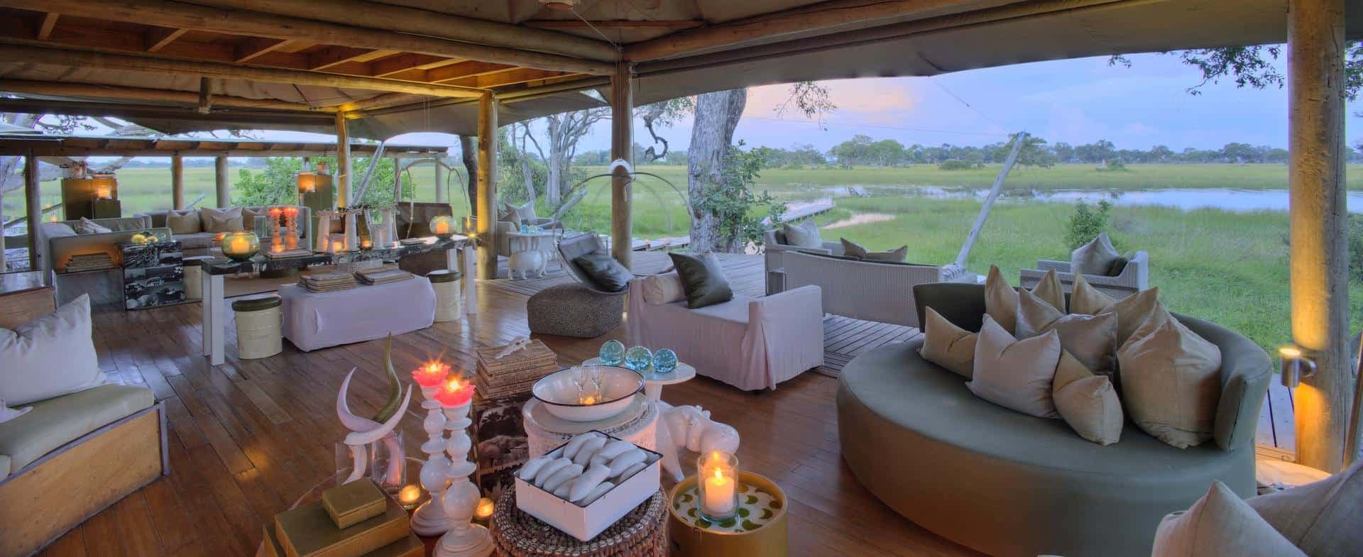 Modern luxury safari lodge architecture with outdoor seating area in the Okavango Delta, Botswana