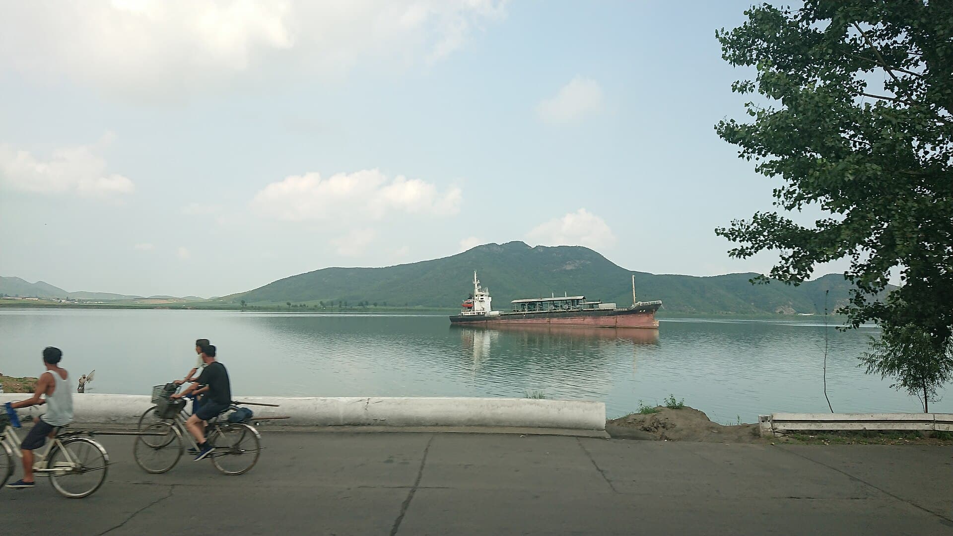 North Korean boat on a river with green banks in North Korea
