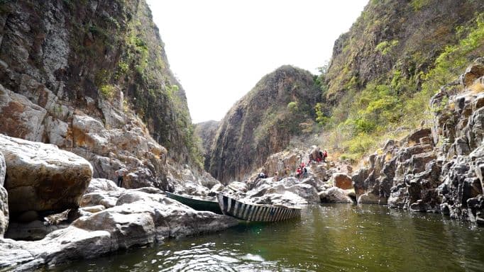 Landscape view of Somoto Canyon in Nicaragua, showing a river flowing through a deep gorge with rocky cliffs