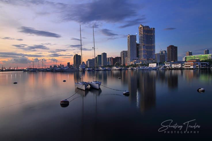 Exterior view of a small harbor with fishing boats docked in the Philippines