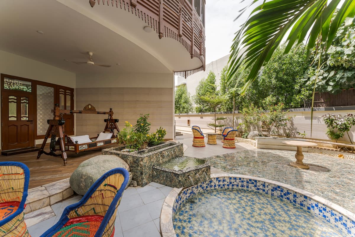 Simple guesthouse exterior with courtyard and traditional Sindhi architectural features in Naushahro Firoz, Pakistan