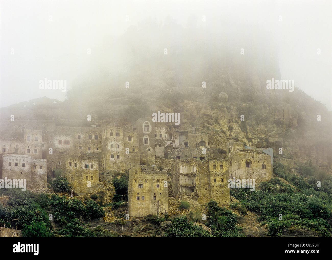 Aerial and ground-level views of a traditional mud-brick village in the mountains of Yemen's Hajjah Governorate