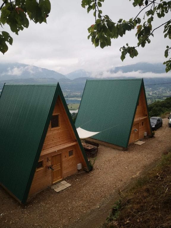 Eco-lodge building exterior in Plav, Montenegro, featuring wooden construction and green roofing, designed for sustainable tourism