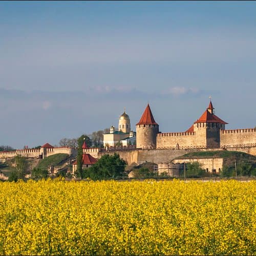 Spring landscape at Noul-Neamț Monastery with ancient churches and blooming wildflowers in Moldova