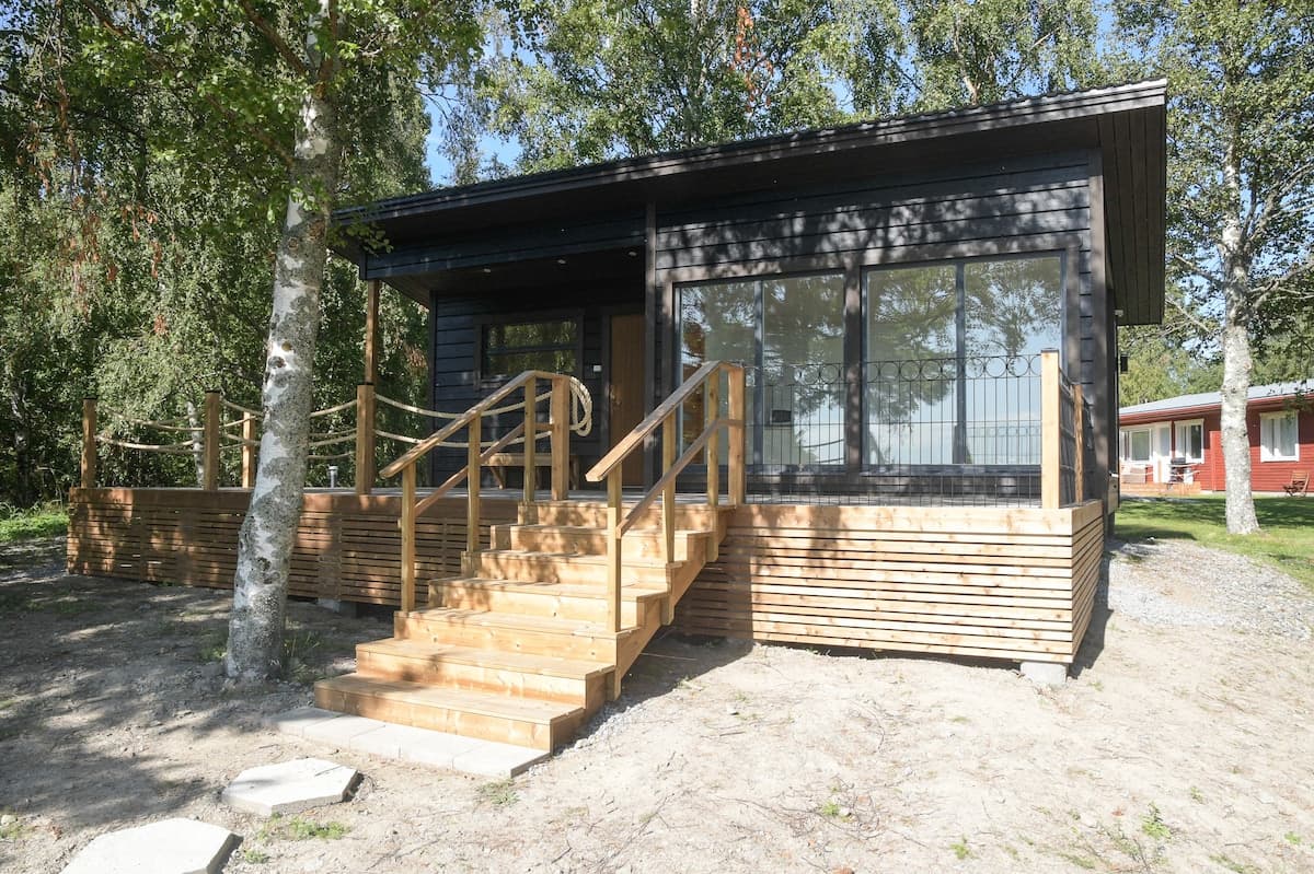 Exterior views of rural guesthouses and forest cabins in Vörå, Finland, in spring