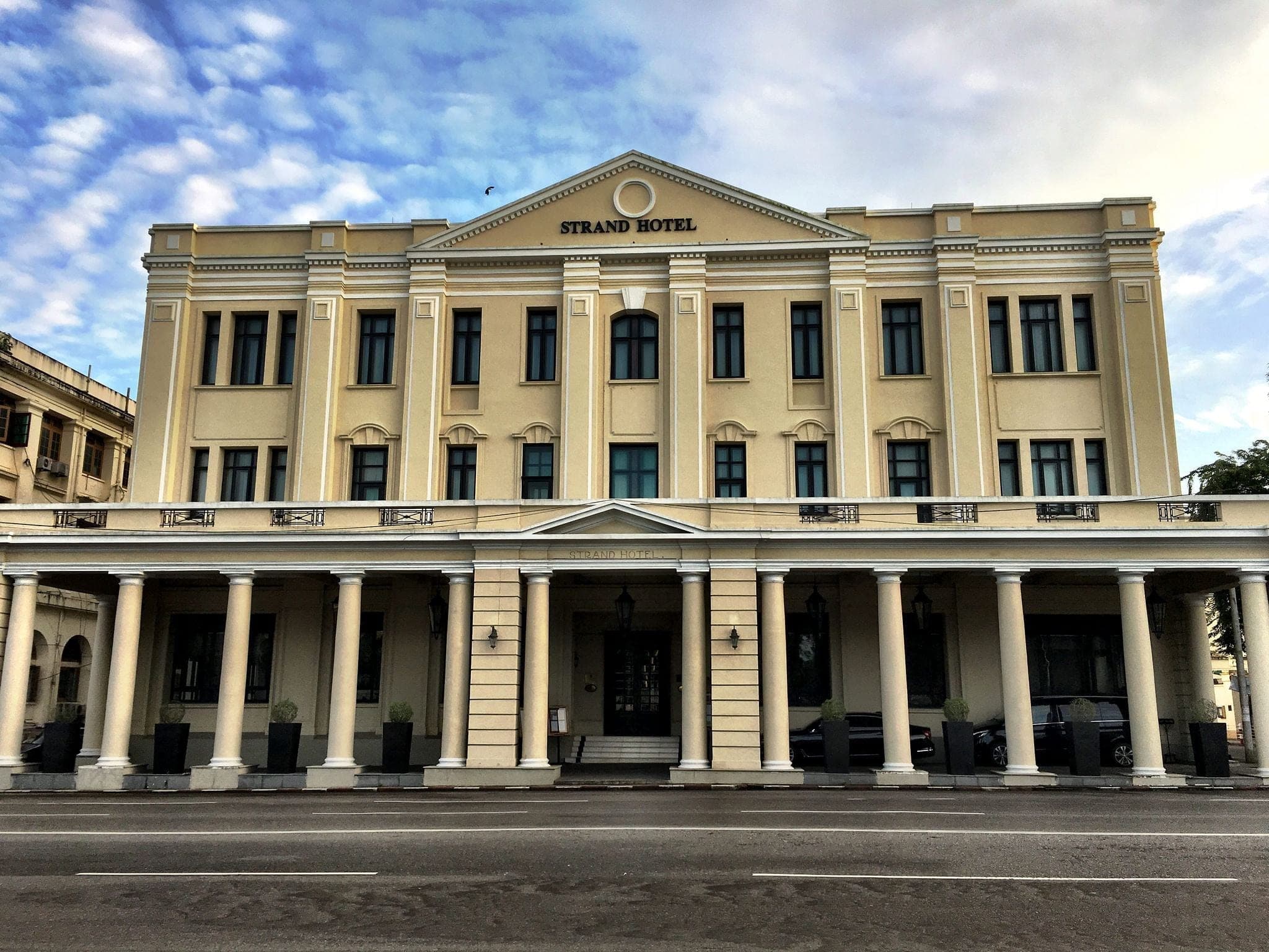 Vintage colonial-style buildings with wooden balconies and stone foundations in Mandalay, Myanmar