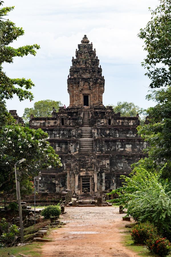Ancient Khmer pyramid structure of Prasat Bakong temple surrounded by trees and greenery in Cambodia