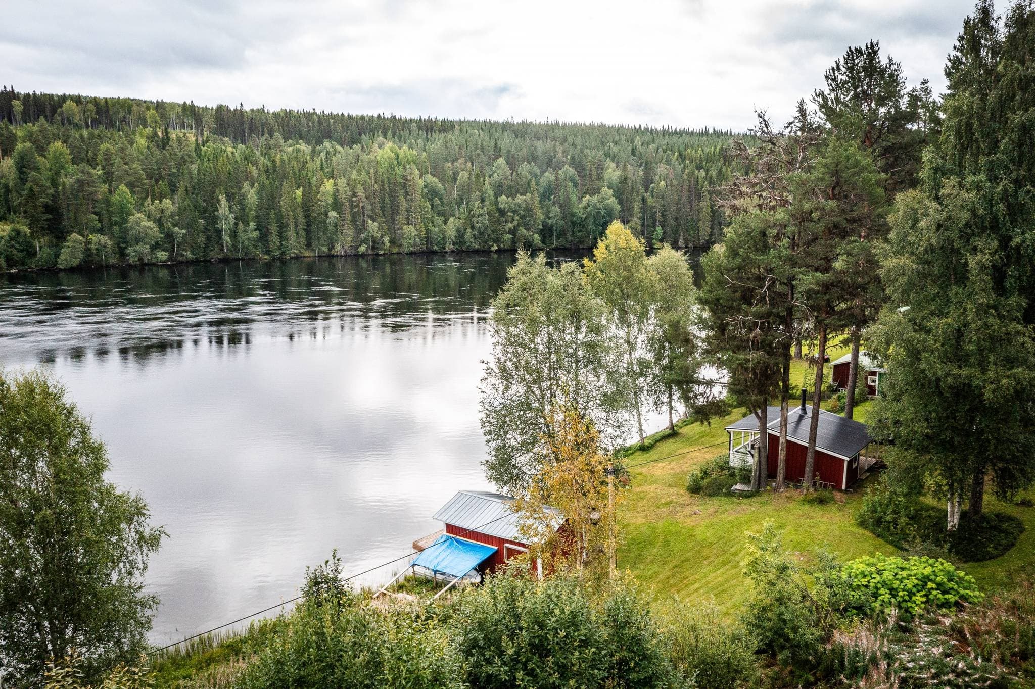 Wide view of forested landscape and river surroundings in Ovanåkers Kommun, Sweden