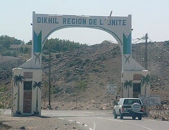 Exterior view of a rural town in Djibouti with travel safety information overlay