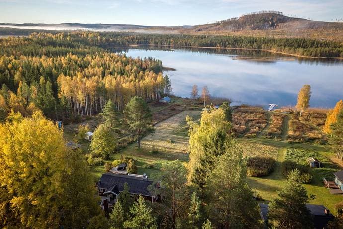 Wide scenic view of a lake and forest landscape in Ovanåkers Kommun, Sweden