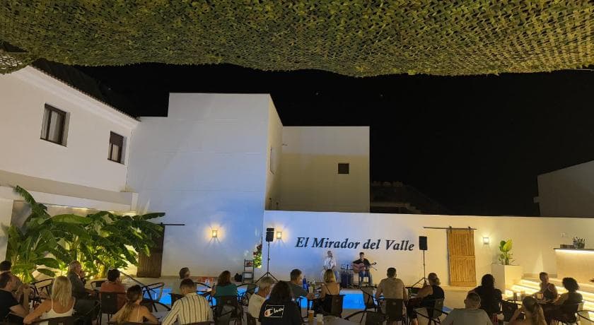 Outdoor seating area of a riverside restaurant in Ayamonte, Spain, with views of the Guadiana River