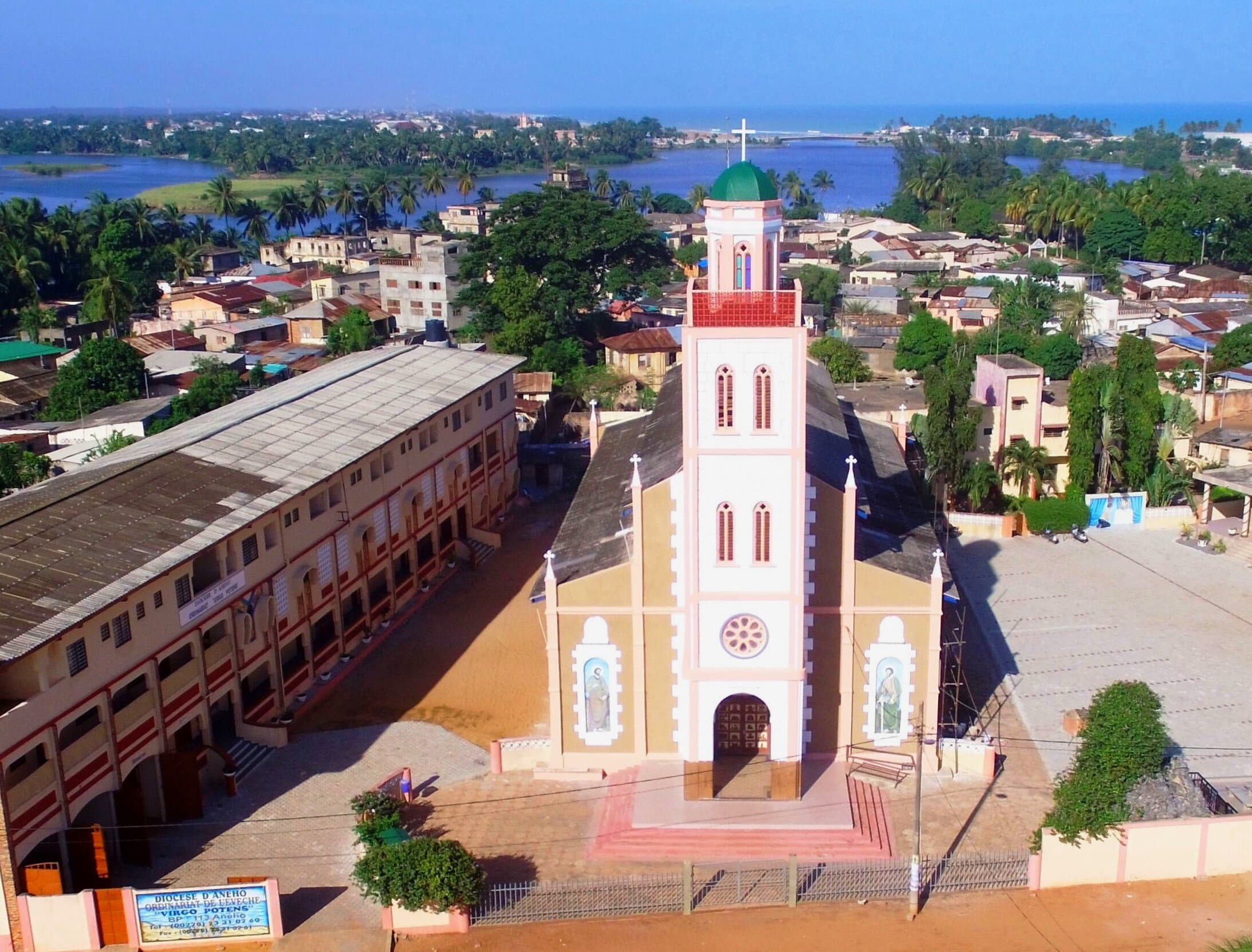 Beachside restaurant exterior in Aného, Togo, with a view of the ocean and colonial-style building facade