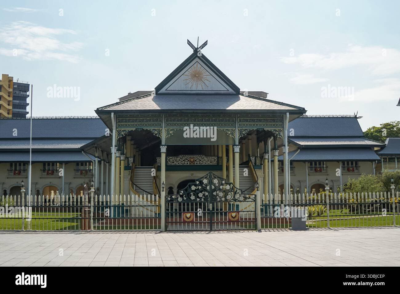 Ornate colonial-style heritage palace with steep roofs and lush gardens in Alor Setar