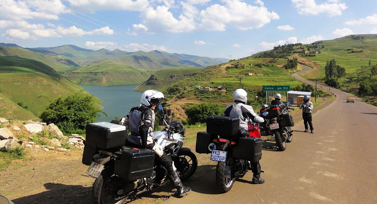 A road through green highlands with a reservoir and rolling hills in rural Eswatini