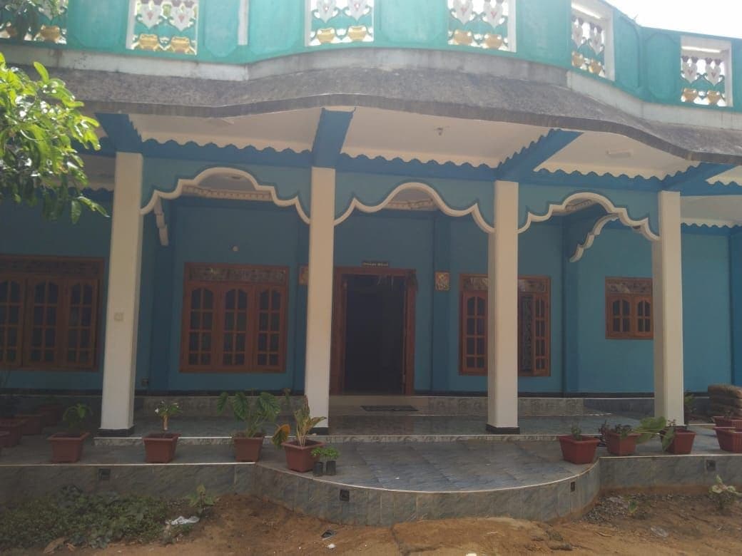 Front view of Hotel Vavuniya, a modest guesthouse with clean exterior and local signage