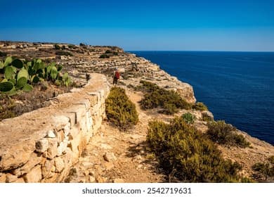 Dramatic red and ochre limestone cliffs overlooking the Mediterranean Sea in southern Malta