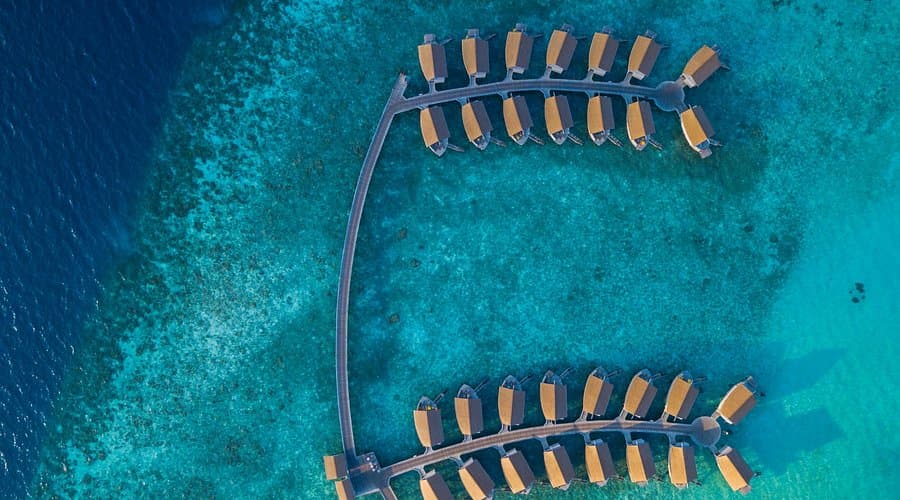 Resort bungalows with private balconies and lagoon views at a 4-star hotel in Veymandoo, Maldives