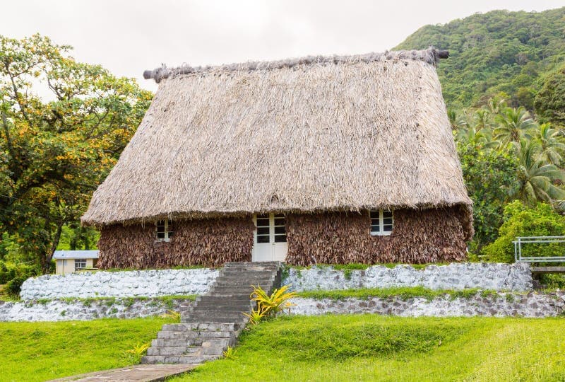 Exterior of a traditional Fijian bure hut with wooden walls and straw roof on Ovalau Island, Lomaiviti Province