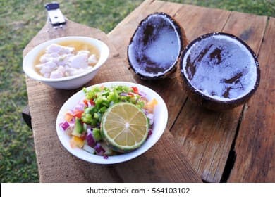 Close-up of fresh fish, lime, and coconut milk ingredients for Fijian kokoda salad, Lomaiviti Province
