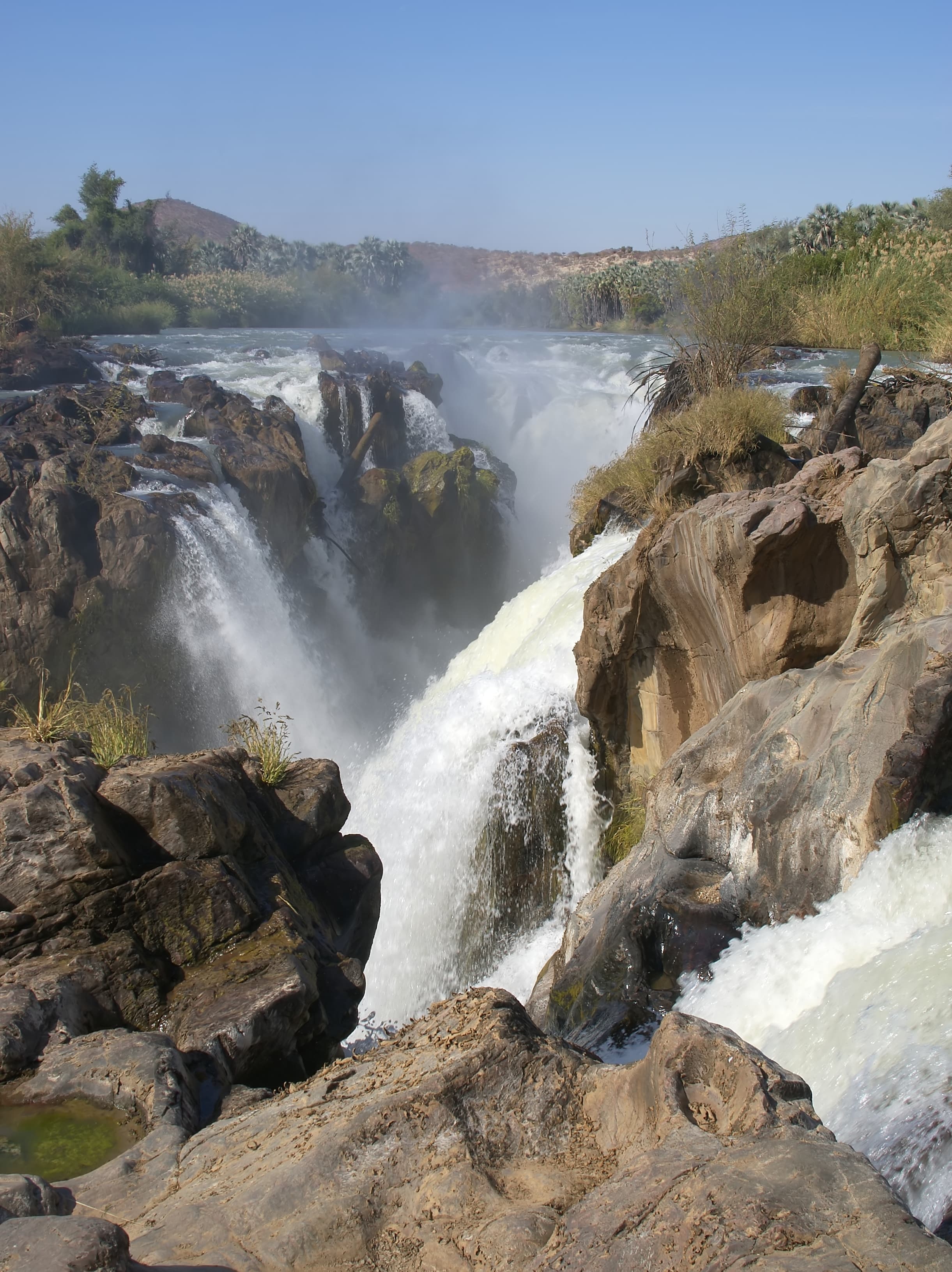Spring landscape in Epupa Constituency, Namibia, showing green riverbanks and natural vegetation along the Kunene River