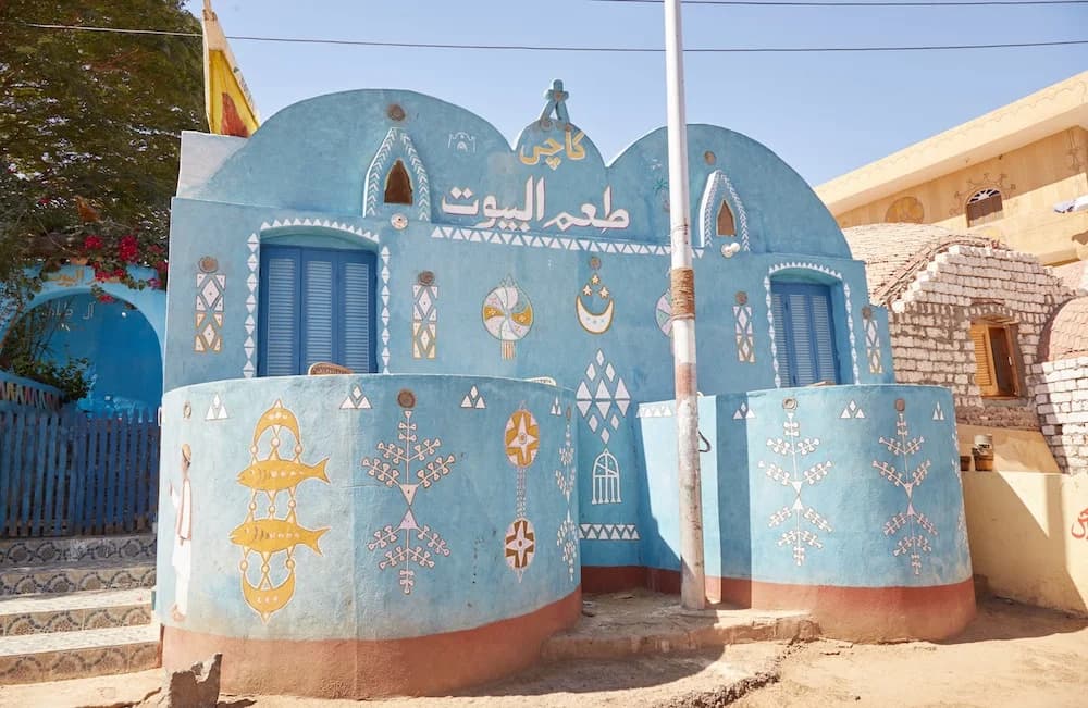 Street view of a Nubian village in Sudan featuring traditional mud-brick homes and narrow alleys