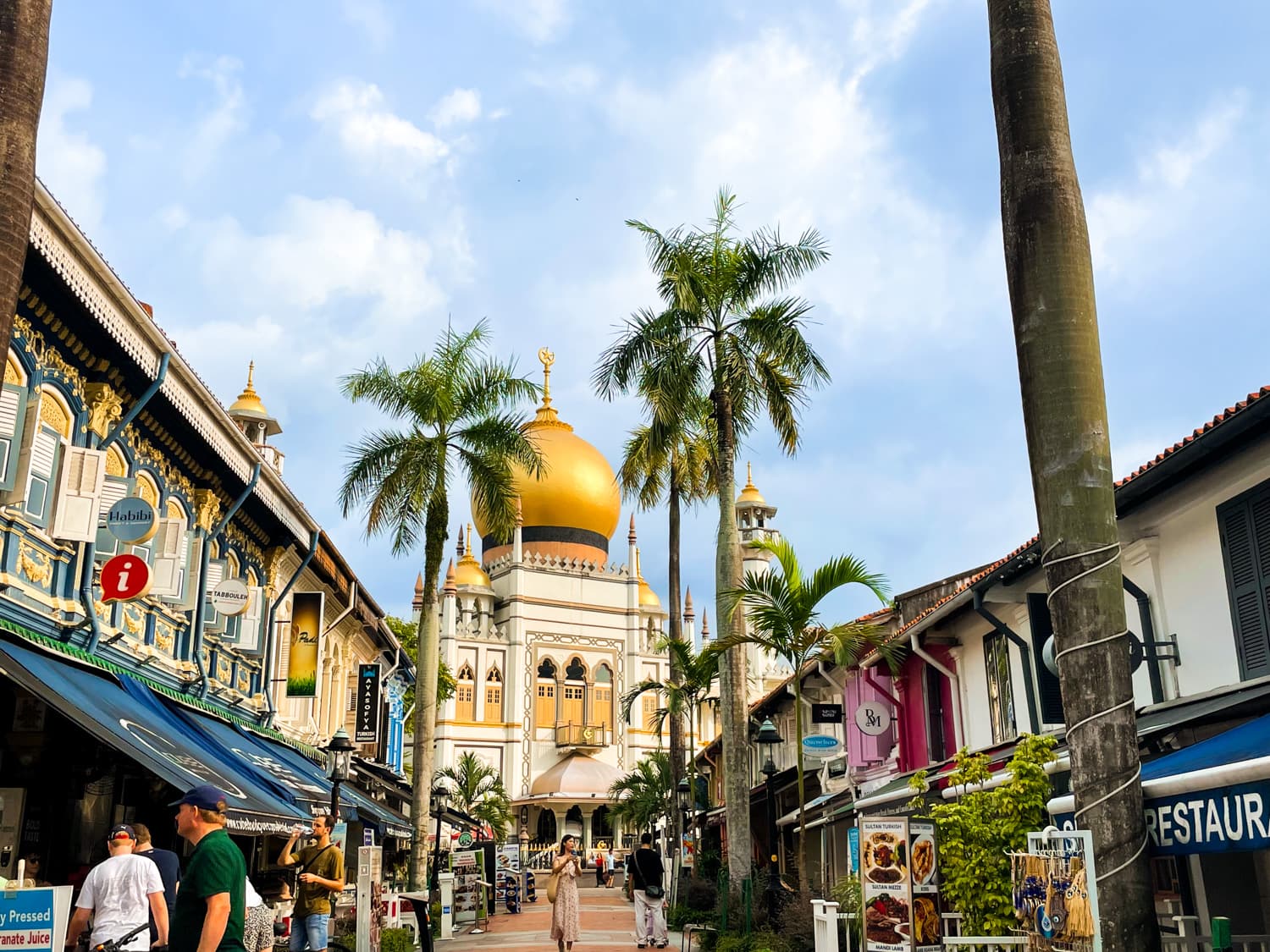 Architectural streetscape of Kampong Glam, Singapore, featuring traditional and modern buildings with the Sultan Mosque in the vicinity